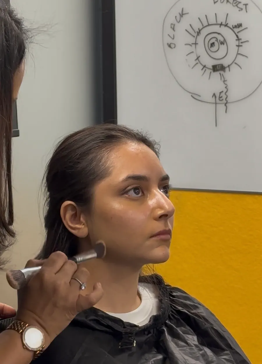 Client having makeup applied at a studio